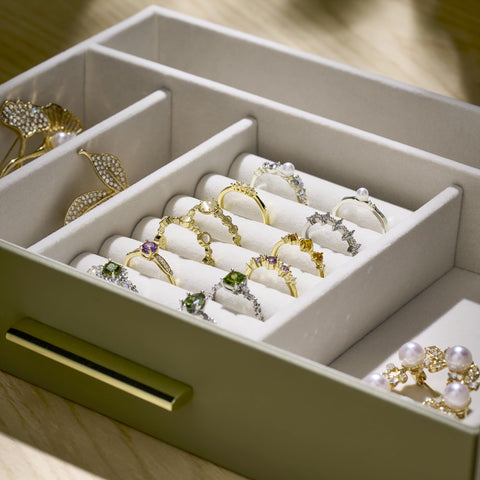 pickpiff jewelry box beside a hand demonstrating compact size and scale