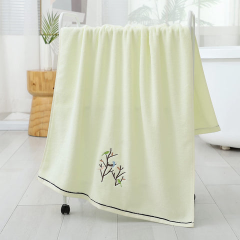Pidada towel next to a hand to show scale, indicates comfortable coverage and portability