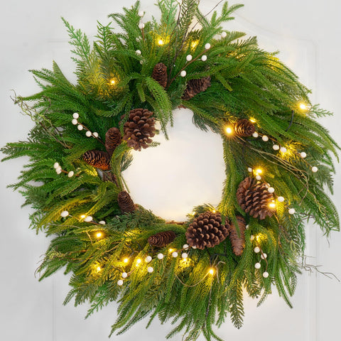 Pinkpuii wreath in home entryway styled with mantel for seasonal decor