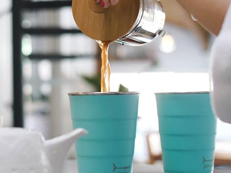 Pirani tumbler held in hand showing size and convenient cup-holder fit