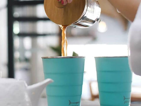 Pirani tumbler held in hand showing size and convenient cup-holder fit