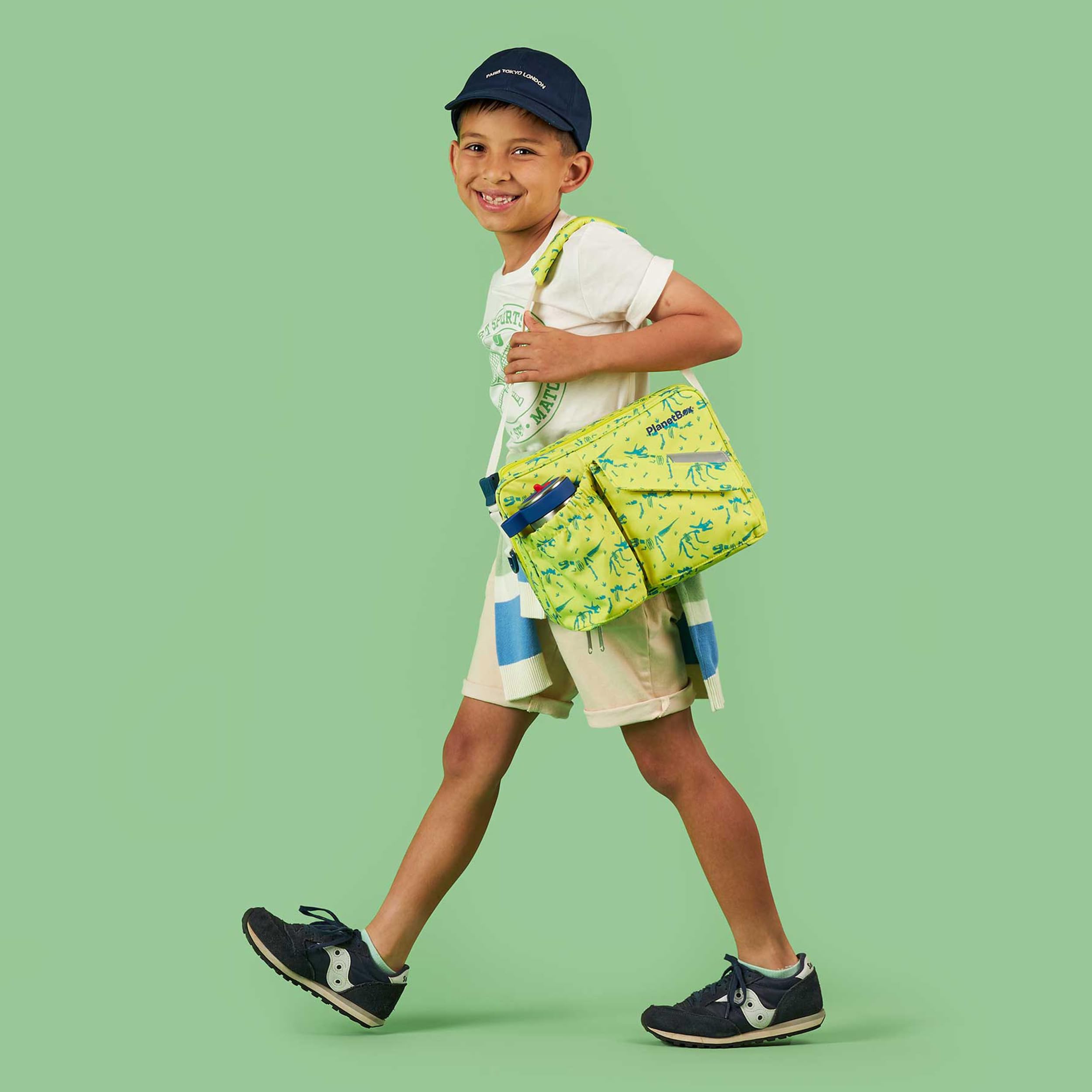 PlanetBox Banana Dino in a school setting being carried by child showing easy transport and kid-friendly design