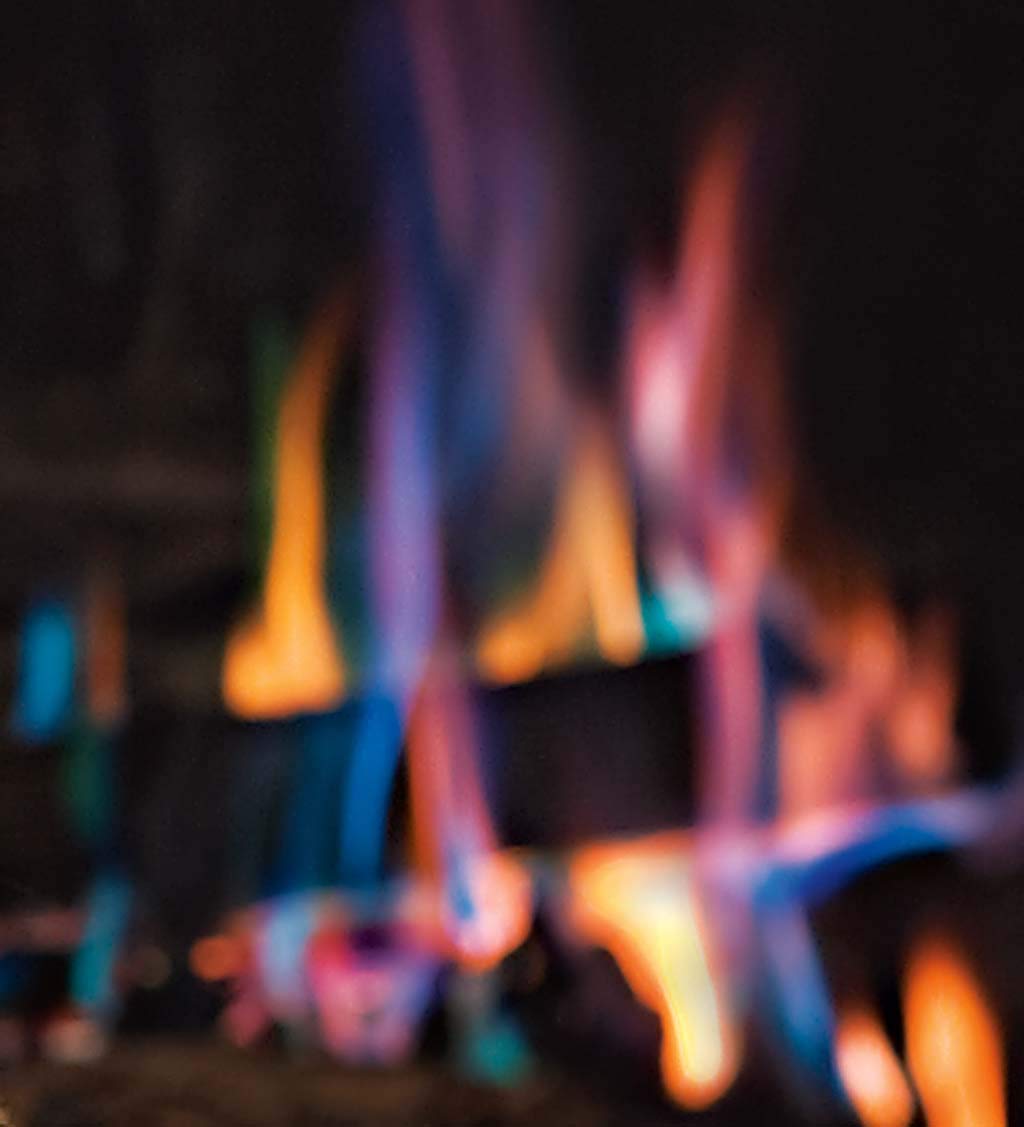 Plow & Hearth cones in an outdoor firepit creating green and blue flame accents