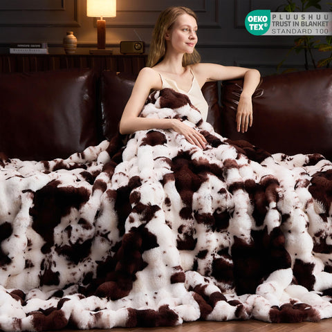 PLUUSHUU blanket draped on sofa lifestyle showing decorative impact and cozy comfort benefit