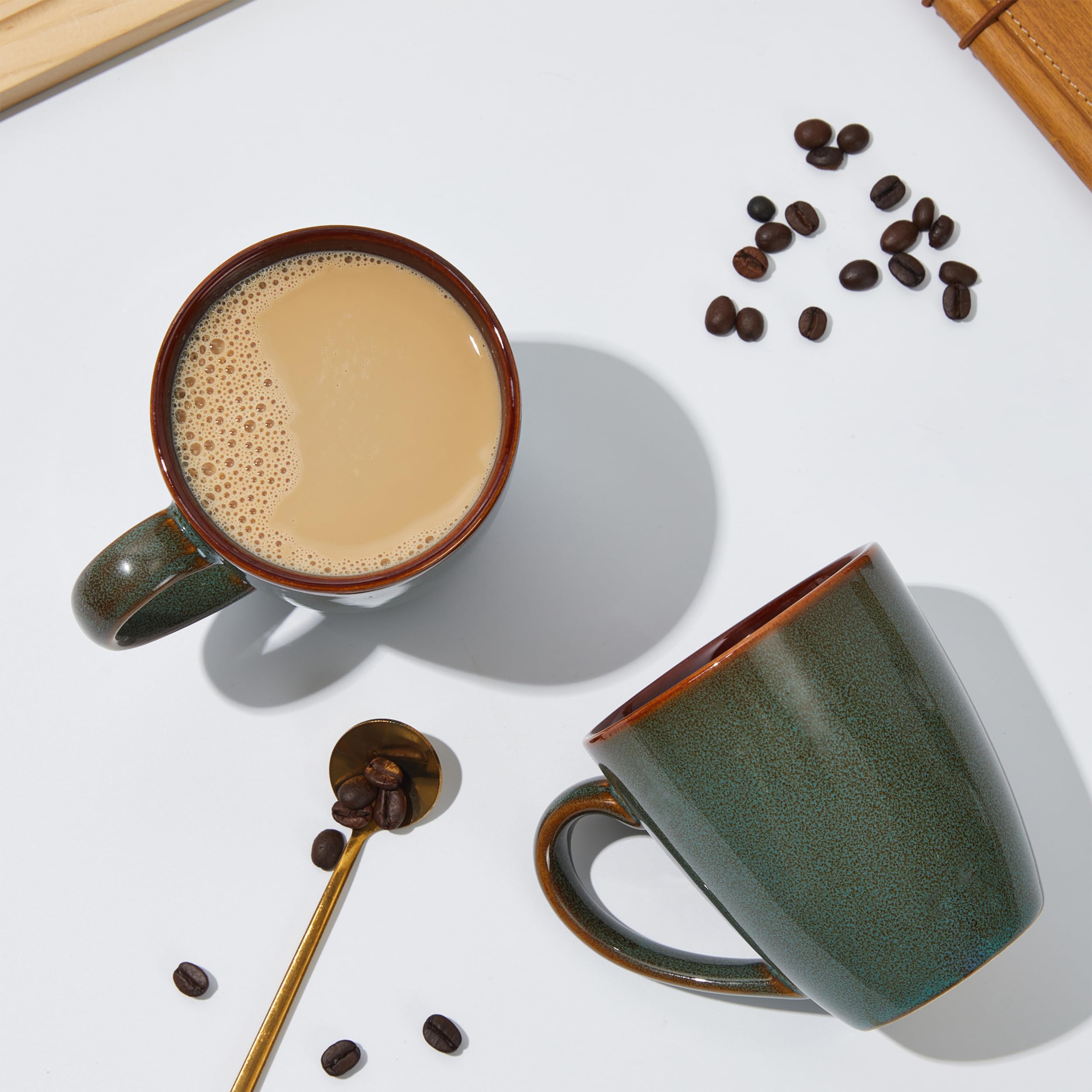 Pokini mug in use with latte pour demonstrating generous 14oz capacity