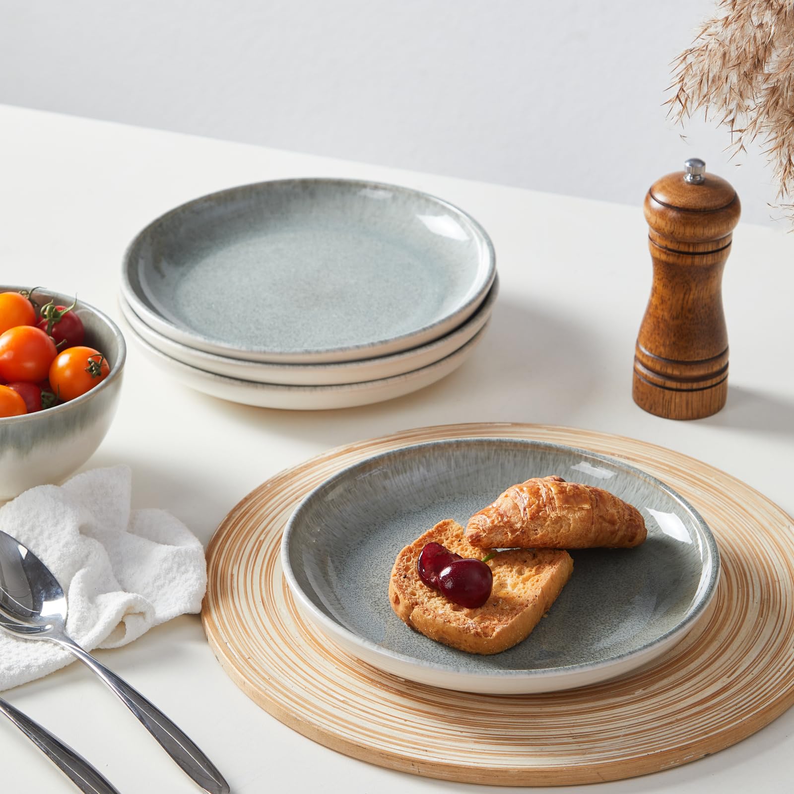 Pokini hand holding plate for size comparison showing practical everyday scale