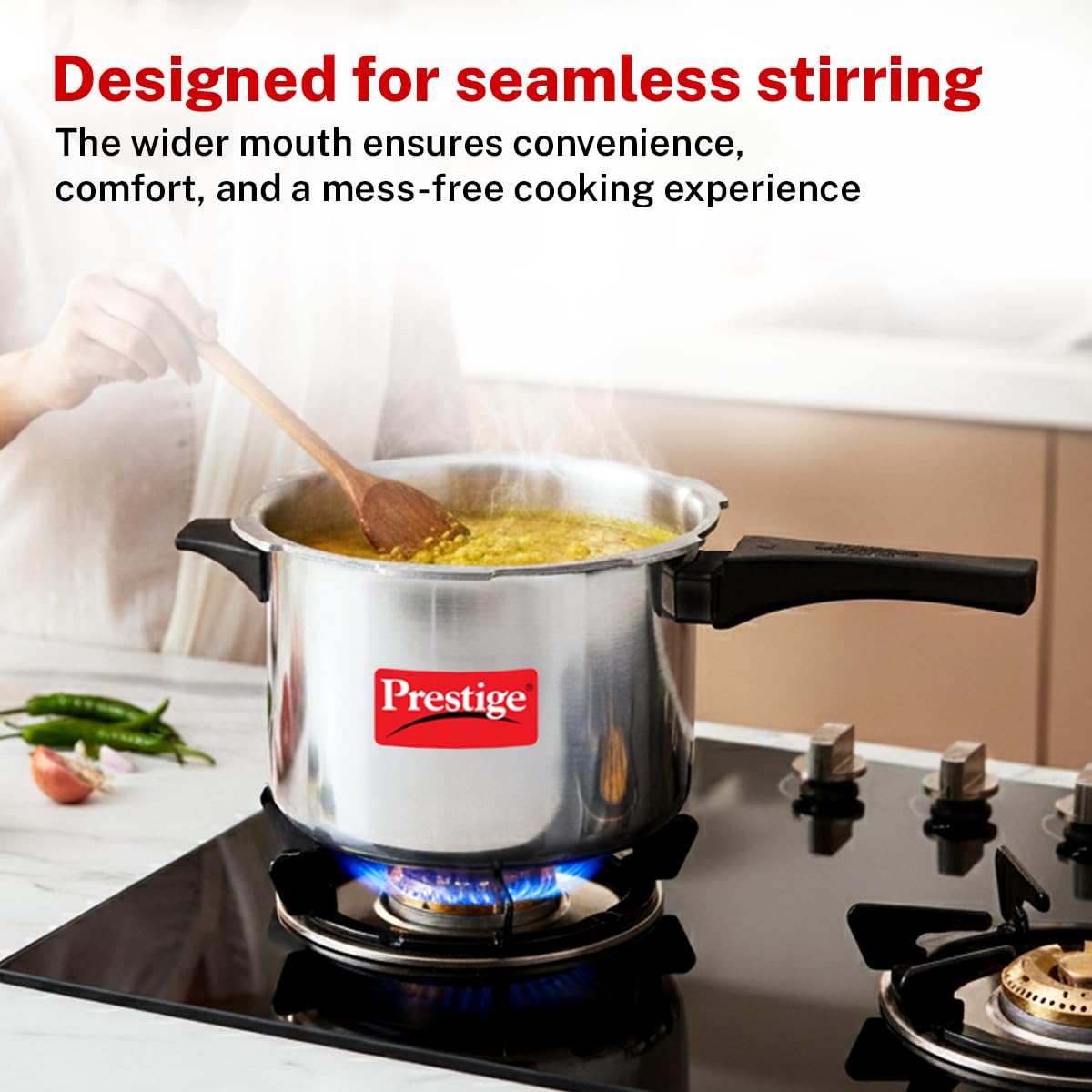 Prestige next to a saucepan to show 5 L capacity and family portion sizing