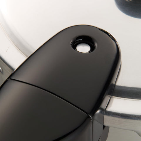 Presto pictured next to a wooden spoon showing scale and large 8‑quart capacity advantage
