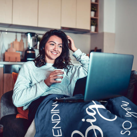Pubrave blanket in use on couch providing comforting coverage and visible message benefit
