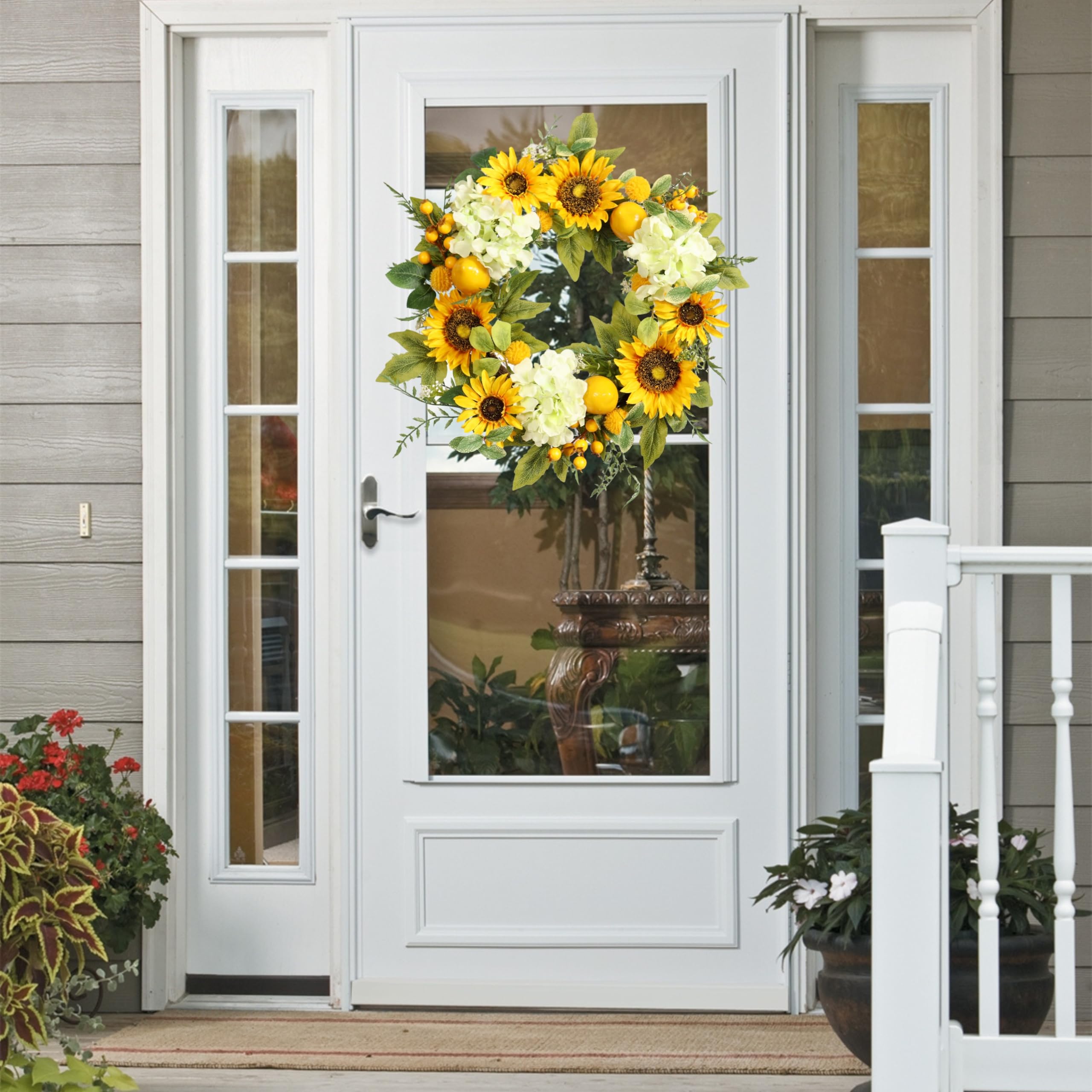 Pudate wreath styled on farmhouse porch creates inviting summer mood