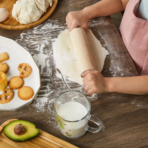Pulcher child using spoon to stir in bowl showing hands-on learning and coordination