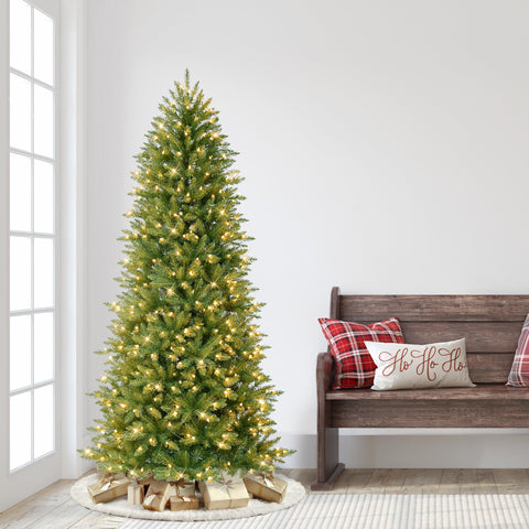 Puleo International tree beside chair showing scale and 6.5 foot height benefit