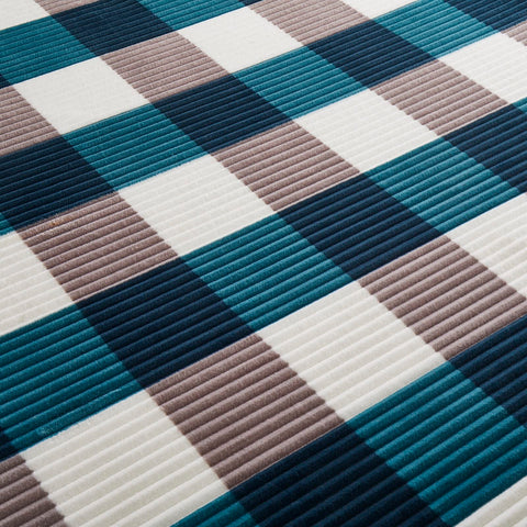 PU MEI blanket on couch in living room, provides comfy lounging comfort