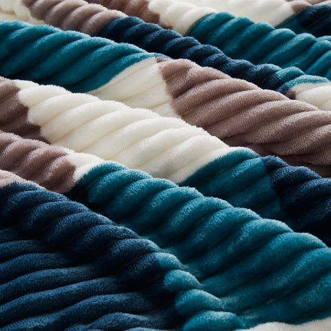 PU MEI blanket draped on twin bed, creates cozy bedroom ambiance