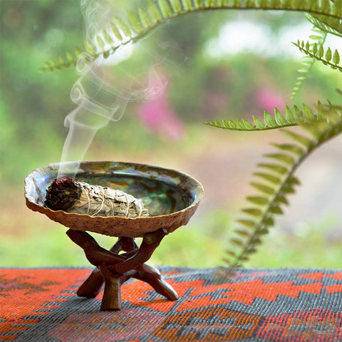 Purple Canyon smudging feather directing smoke during ritual for focused practice benefit