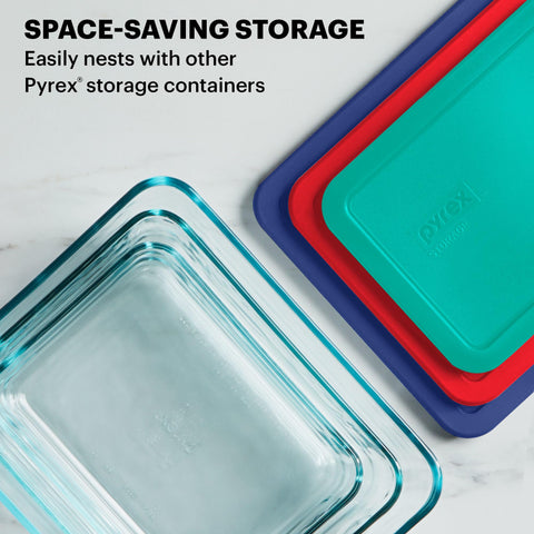 Pyrex three- and six-cup containers next to common utensils for scale