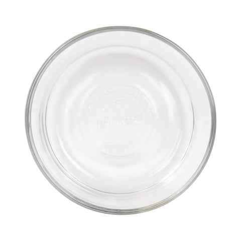 Pyrex stacked bowls next to measuring cup showing 2-cup size and space-saving benefit