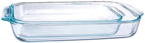 Pyrex dishes next to measuring spoon for scale, illustrating portion capacity
