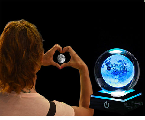 Qianwei on a nightstand providing soft ambient science-themed lighting