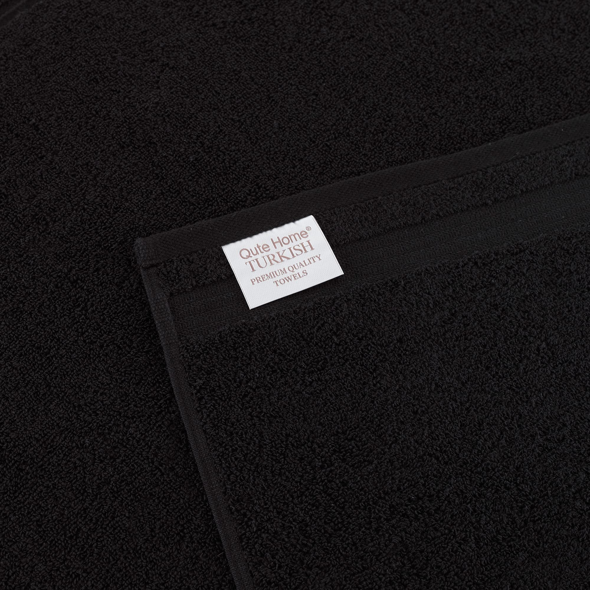 Qute Home towels stacked on shelf showing coordinated storage and tidy look