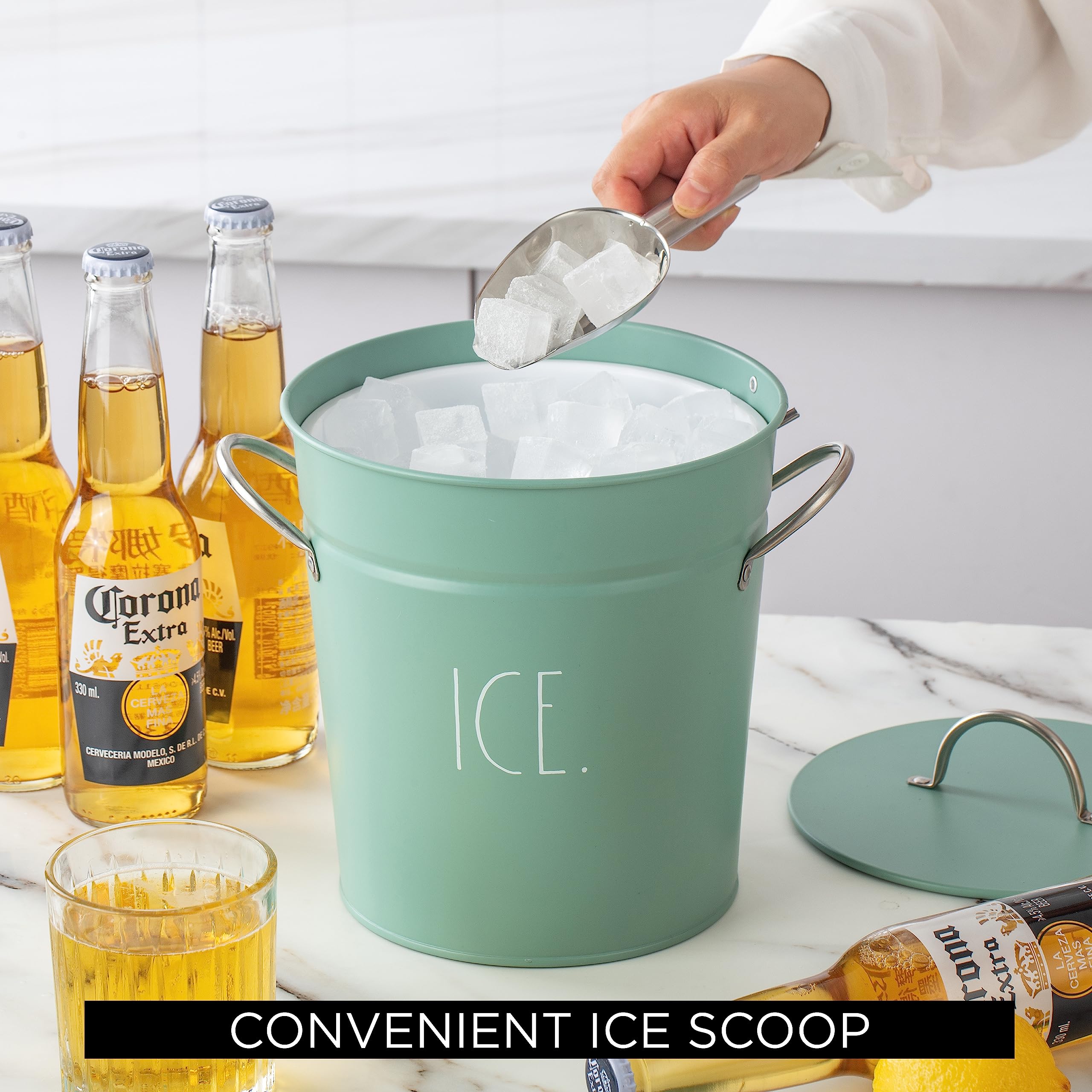 Rae Dunn ice bucket next to glass and bottle for size and capacity reference