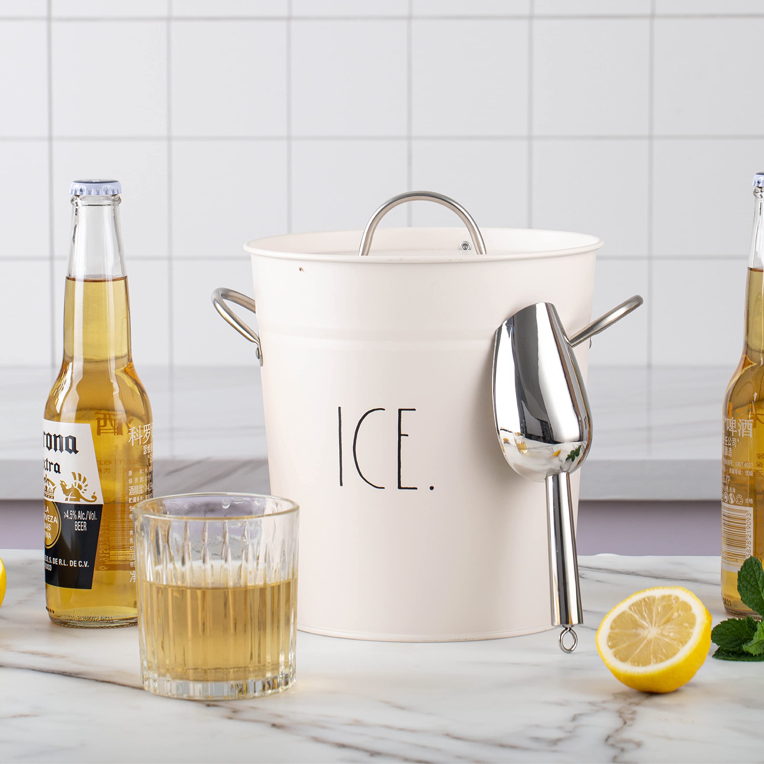 Rae Dunn ice bucket beside glass for scale to illustrate compact capacity