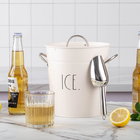 Rae Dunn ice bucket beside glass for scale to illustrate compact capacity