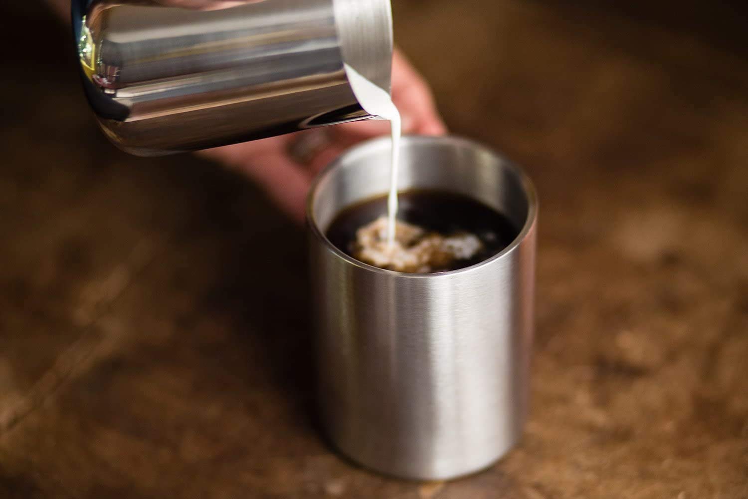 Real Deal Steel mug in hand for size comparison demonstrating lightweight portability