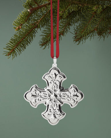 Reed & Barton cross ornament on mantel in holiday setting adding elegant charm benefit