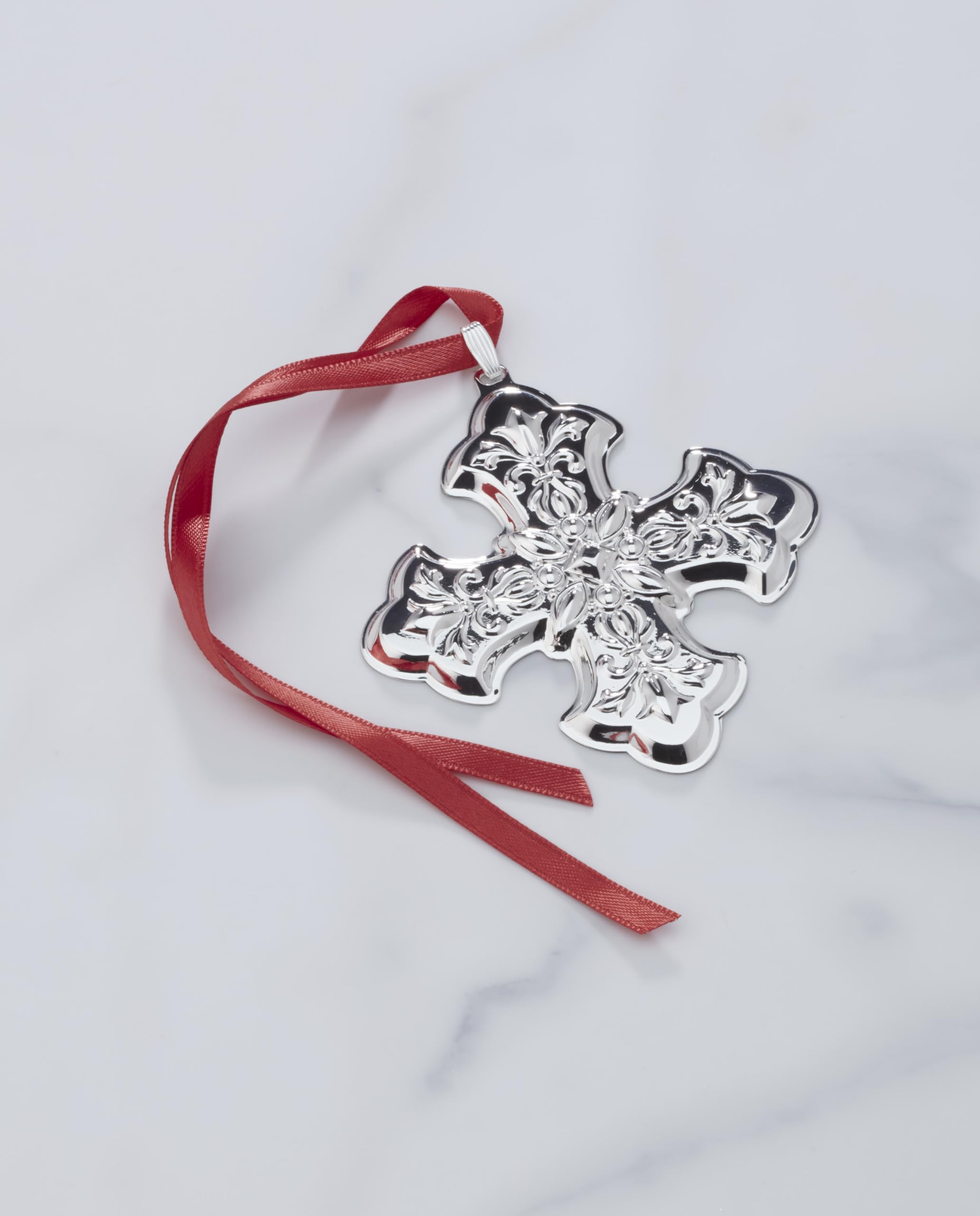 Reed & Barton ornament hanging on tree with red ribbon for festive display benefit