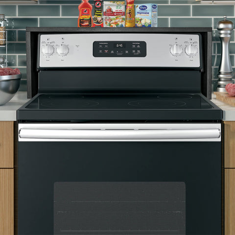 RELODECOR ebony installed above glass-top range showing fit and safety advantage