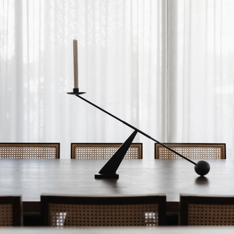 Remenna candlestick with lit tapered candle demonstrating ambient lighting benefit