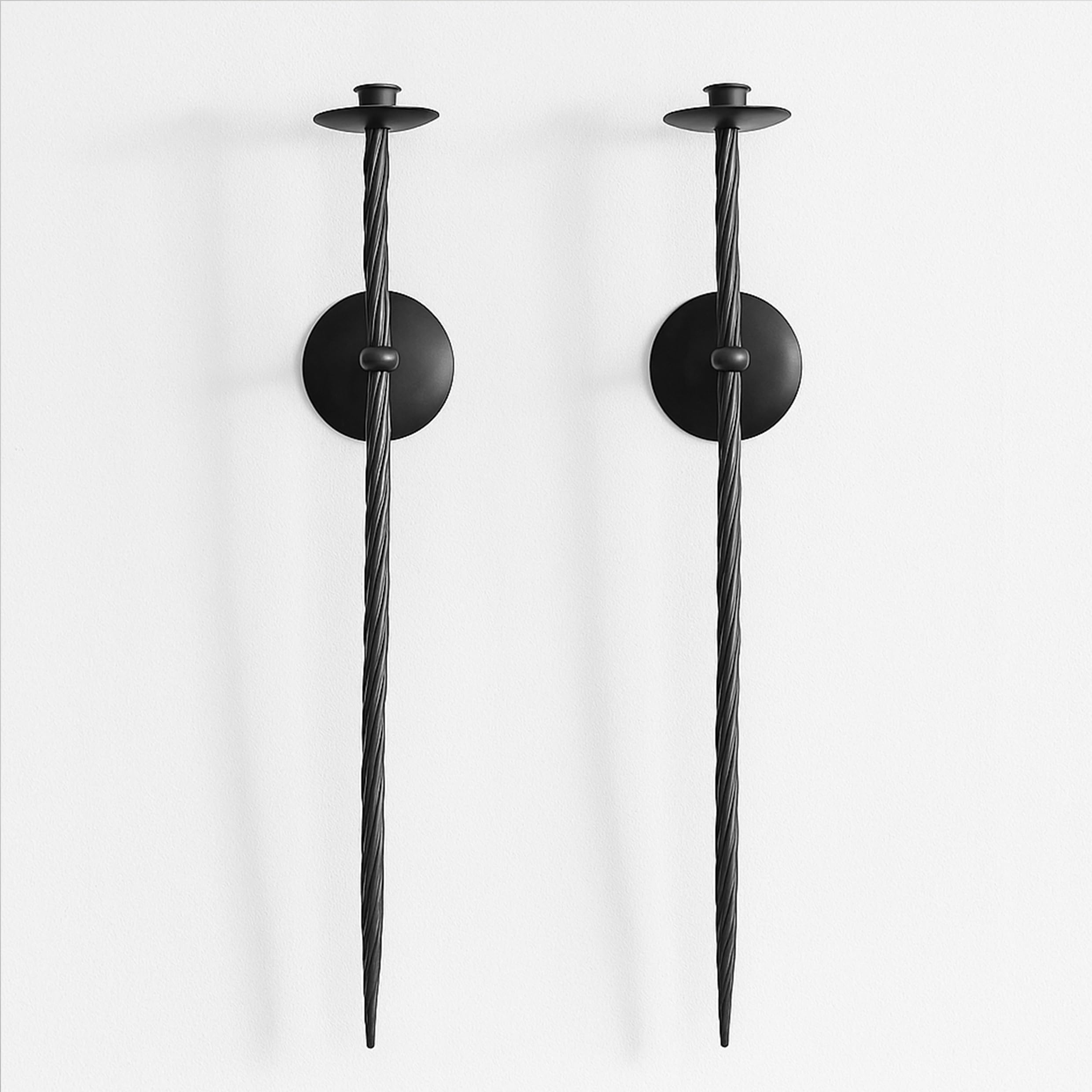 Remenna front view showing pair of black twisted wall candle holders, adds dramatic accent