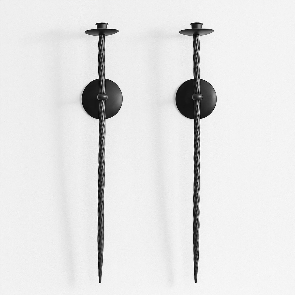 Remenna front view showing pair of black twisted wall candle holders, adds dramatic accent