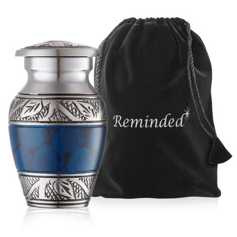 Reminded urn held in hand for scale, demonstrating compact keepsake size benefit