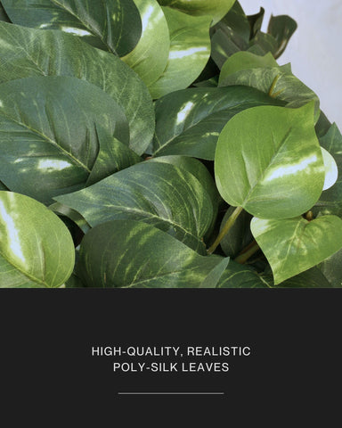 Retrograde faux pothos staged in included minimalist pot for instant tabletop greenery