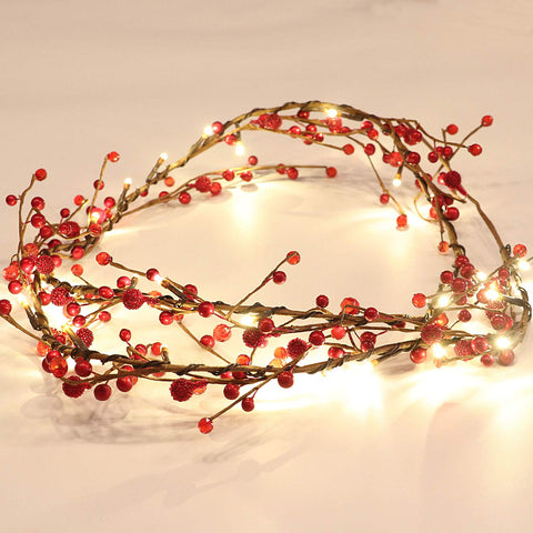 Rhytsing front view of garlands showing red berries and warm lights, festive appeal