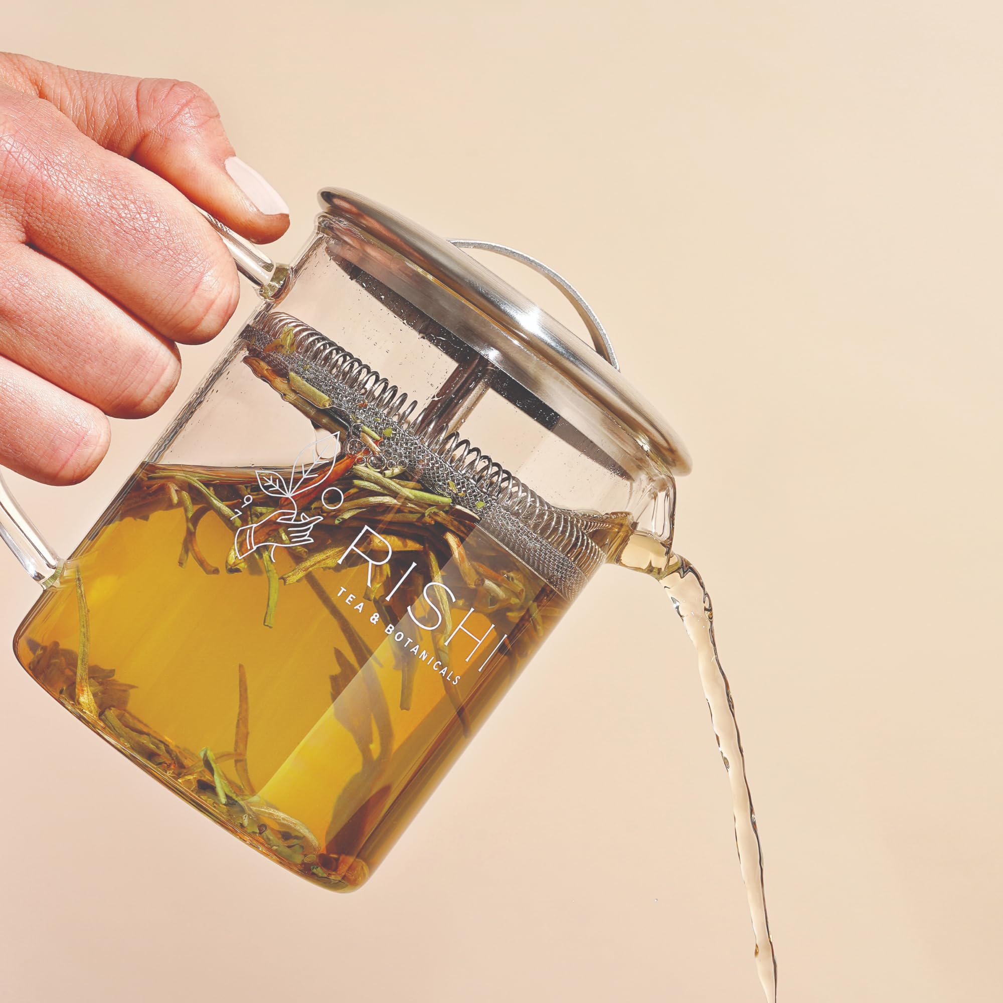 Rishi Tea Simple Brew pouring tea into cup, clean strained pour and visual control