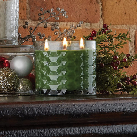 Root candle placed in living room setting creating cozy atmosphere and seasonal ambiance