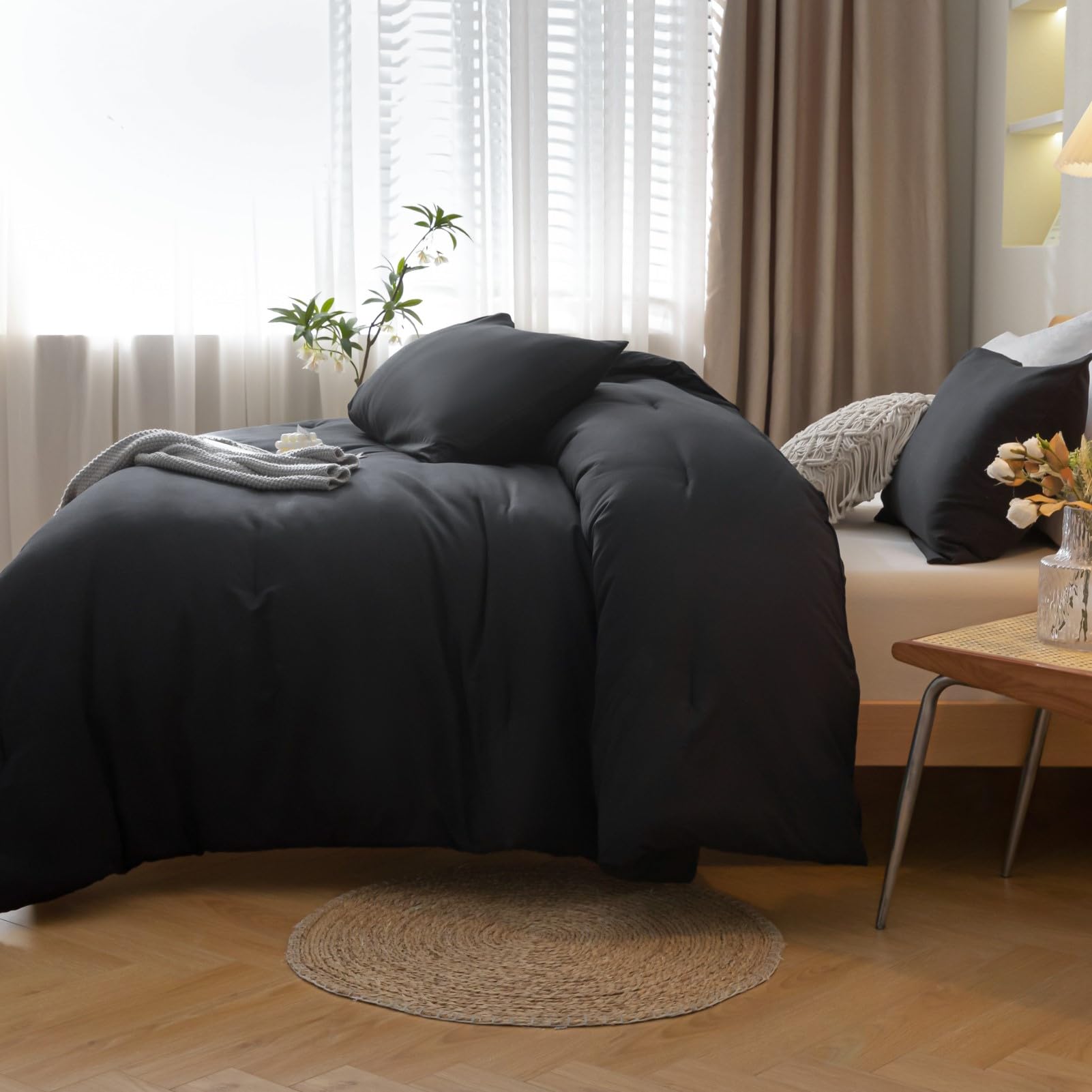 ROSGONIA styled full bed in bedroom, black comforter adds sleek warmth