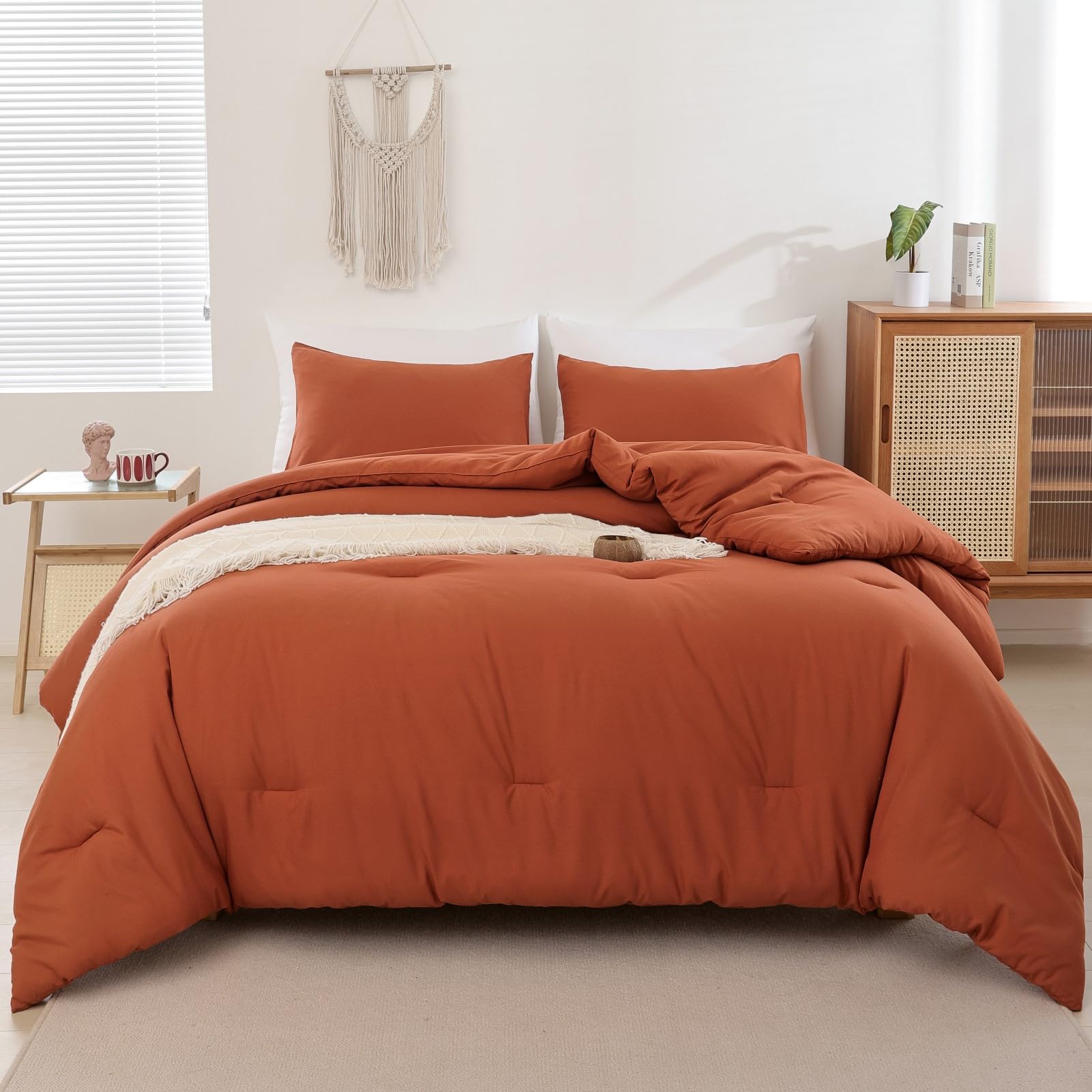 ROSGONIA comforter styled on queen bed, demonstrates warm boho bedroom appeal