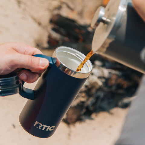 RTIC mug held in hand for size and 16oz capacity visual scale benefit