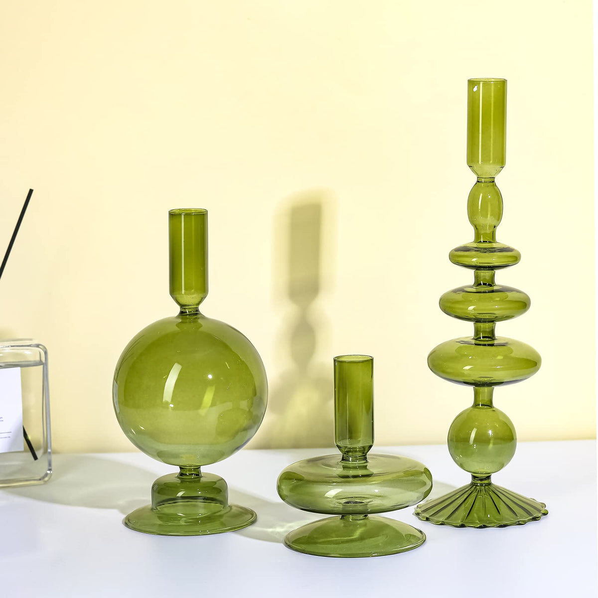 Rtteri front view of three green glass candlesticks showing elegant tiered display and ambiance