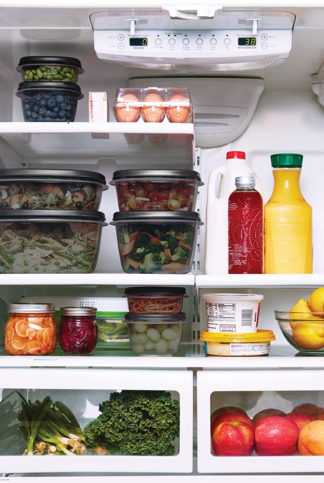 Rubbermaid containers stacked in freezer with labels for meal prep
