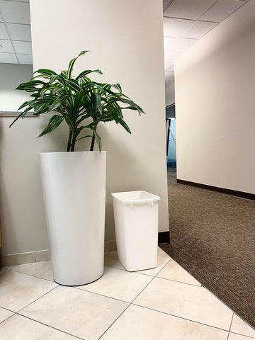 Rubbermaid trash can beside toilet demonstrating compact size and space saving