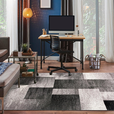 Rugshop next to sofa showing 5x7 scale to help visualize room fit