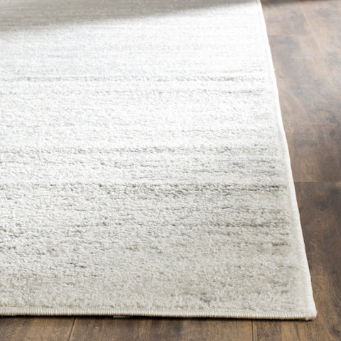 SAFAVIEH Adirondack in living room showing how rug anchors furniture and space