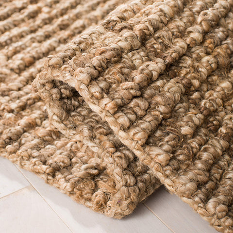 SAFAVIEH rug under coffee table illustrating layered living room warmth