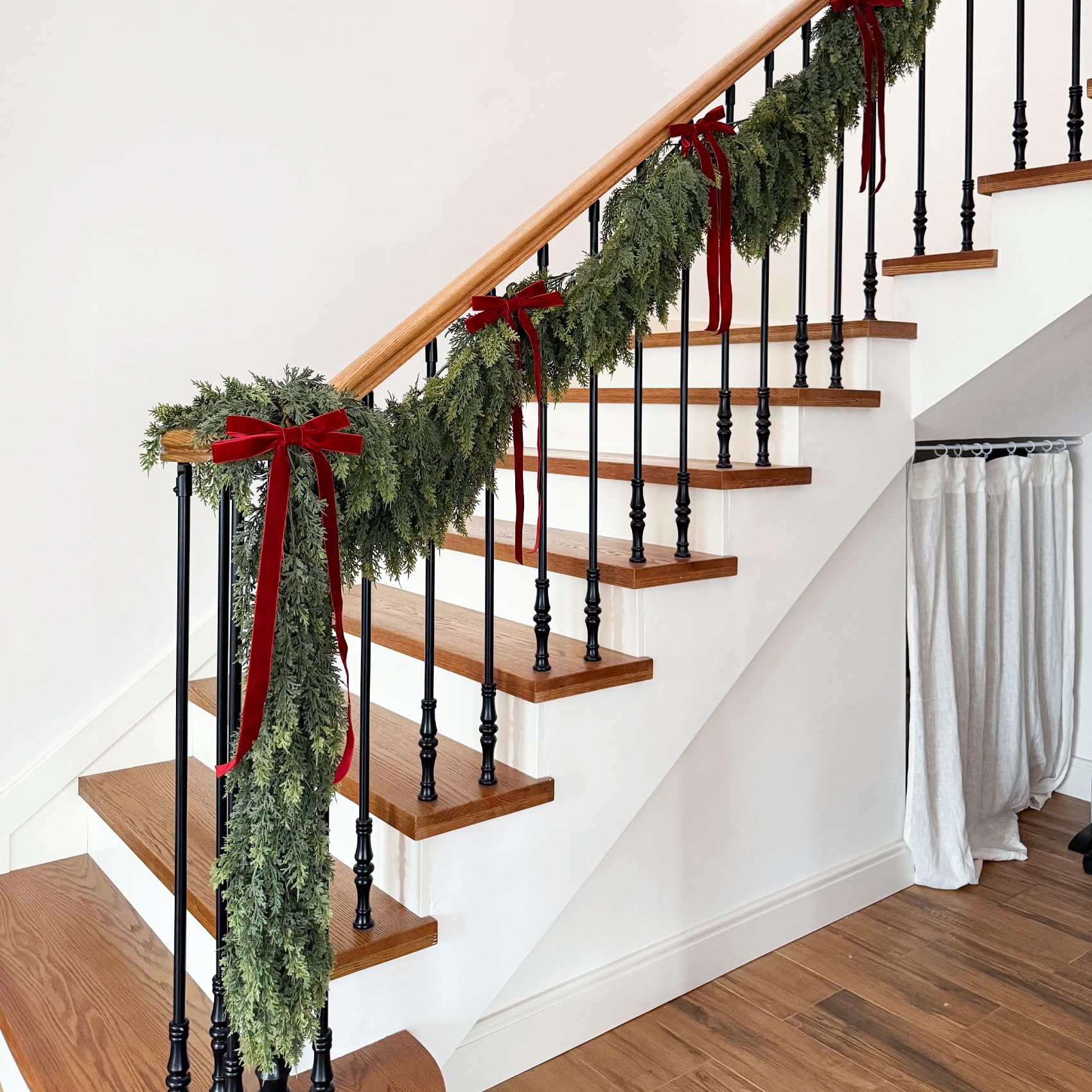 Senjie garland wrapped around stair rail creating elegant staircase styling