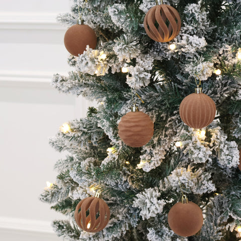 Senjie ornament next to hand to show 3.15-inch scale for sizing clarity